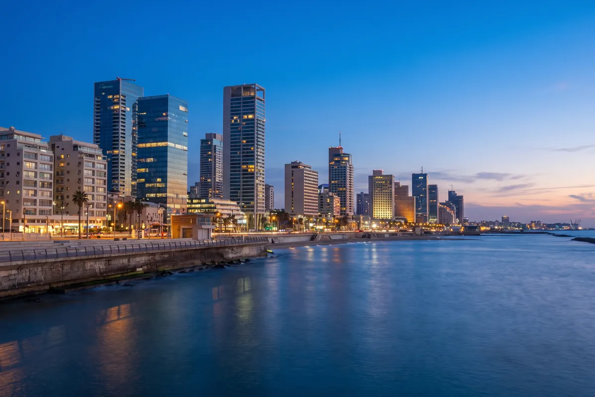 Tel Aviv illuminated at dusk by the sea